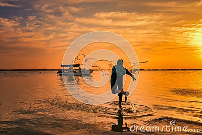 Silhouettes of the fishermen throwing fishing net during sunset in Dammam seaside Saudi Arabia Editorial Stock Photo