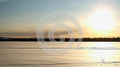 Silhouettes of group of people with snowscooter on frozen solid lake Norsjon in Vasterbotten, Sweden Stock Photo