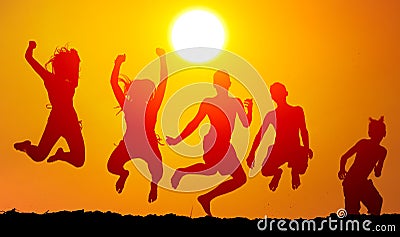 Silhouettes of happy teenagers jumping high Stock Photo