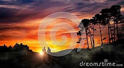 Silhouettes of lovers walking along the road towards the dawn Stock Photo