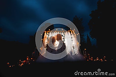 Silhouettes of man and woman kiss, night scene, back light, concept of love, valentines day Stock Photo