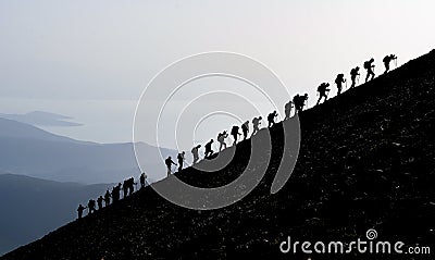 Mountaineers hiking uphill Stock Photo