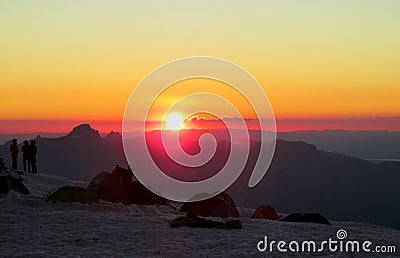 Silhouettes of people ant tents in the mountains at sunset light Editorial Stock Photo