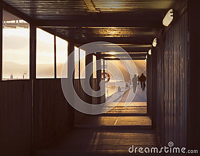 Silhouettes of people at beautiful, early dawn by the water. Stock Photo