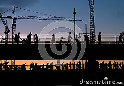 Silhouettes of people crossing bridge with sunset sky background Editorial Stock Photo