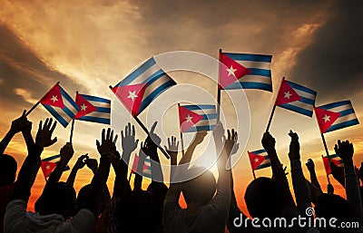 Silhouettes of People Holding Flag of Cuba Stock Photo