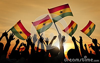 Silhouettes of People Holding Flag of Ghana Stock Photo