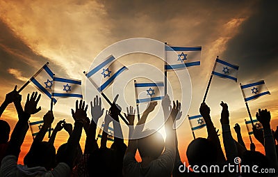 Silhouettes of People Holding Flag of Israel Stock Photo