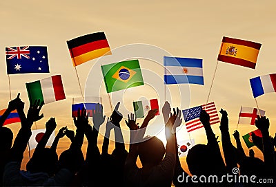 Silhouettes of People Holding Flags From Various Countries Stock Photo