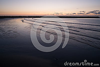 Silhouettes of people on evening Beach Stock Photo