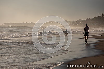 Silhouettes of a people and surfers at the beach. Editorial Stock Photo