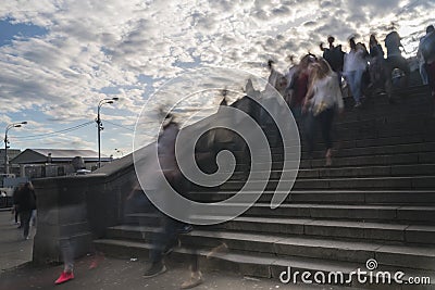 Silhouettes of people walk the stairs of the stone bridge Editorial Stock Photo