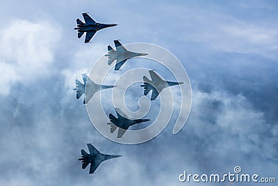 Silhouettes of russian fighter aircrafts SU-27 in the sky Stock Photo