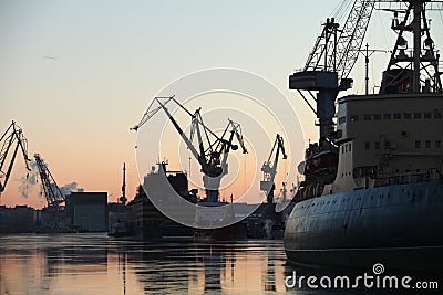 Silhouettes of ships and portal cranes Stock Photo