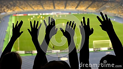 Silhouettes of soccer fans hands during match, crowded football stadium, sport Stock Photo