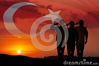 Silhouettes of soldiers on a background of Turkey flag and the sunset or the sunrise. Stock Photo