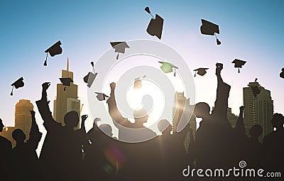 Silhouettes of students throwing mortarboards Stock Photo