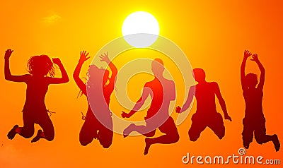 Silhouettes of teenage boys and girls jumping high in the air on Stock Photo