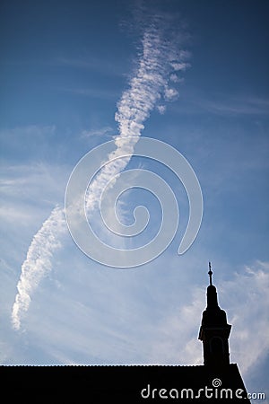 Silhouettes of towers and architectural parts with blue sky and white clouds Stock Photo