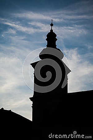 Silhouettes of towers and architectural parts with blue sky and white clouds Stock Photo