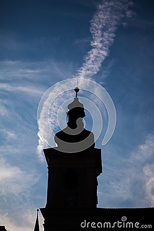 Silhouettes of towers and architectural parts with blue sky and white clouds Stock Photo