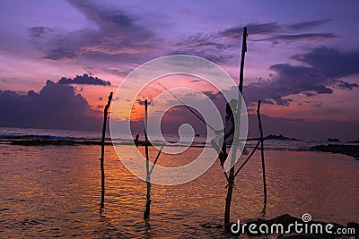 Silhouettes of the traditional Sri Lankan stilt fishermen Stock Photo