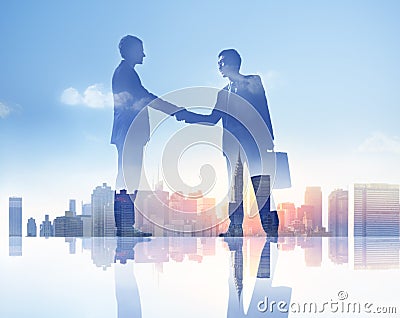 Silhouettes of Two Businessmen Having a Handshake Stock Photo