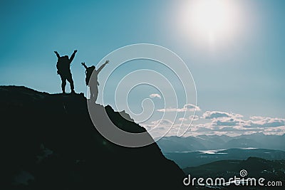Silhouettes of two hikers on mountain top Stock Photo