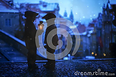 Silhouettes of two kids, standing on a stairs, holding a lantern Stock Photo