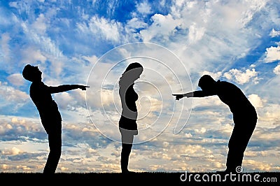 Silhouettes of two men laughing at a woman showing a finger at her Stock Photo