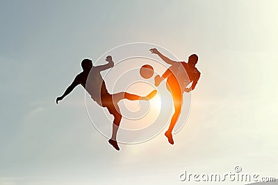 Silhouettes of two soccer players Stock Photo