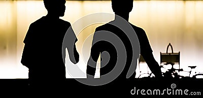 Silhouettes of two teen boys walking in the summer night Stock Photo