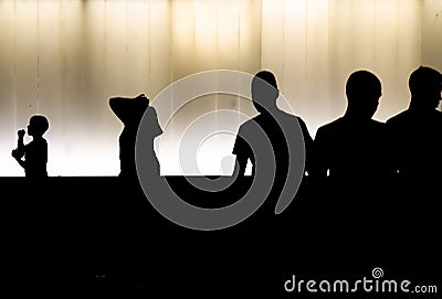 Silhouettes of young boys walking in the summer night in high contrast black and white Stock Photo