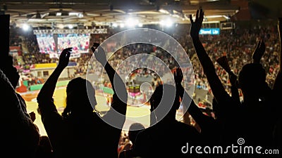 Crowd cheering at basketball stadium Stock Photo