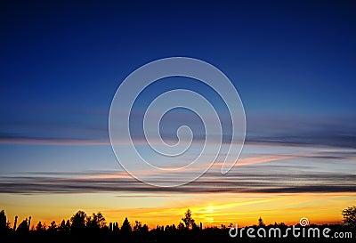 Silhoutte of tree and islands at far with vivid color of the sky during sunset Stock Photo