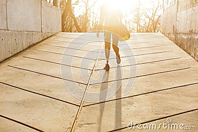 Silhuette of sunlit athletic disabled girl with prosthetic leg i Stock Photo