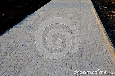 Silica sand fraction 0-4 mm used as a material for backfilling the joints between the tiles of concrete gray interlocking paving Stock Photo