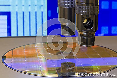 Silicon wafer with semiconductor microchip on machine process examining testing in microscope Stock Photo