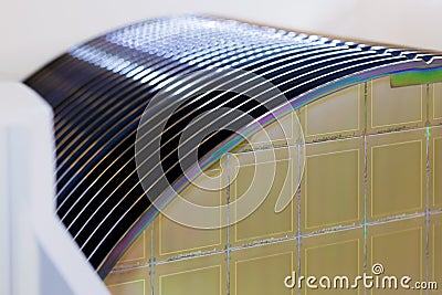 Silicon Wafers in white plastic holder box on a table- A wafer is a thin slice of semiconductor material, such as a crystalline Stock Photo