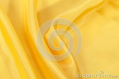 Silk background, texture of yellow shiny fabric Stock Photo