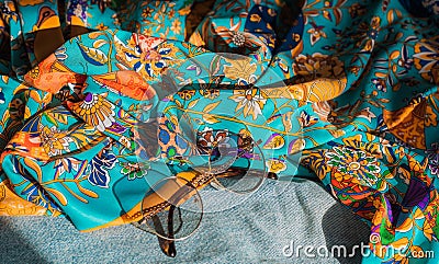 Silk clothes abstract texture and hippie sun glasses Stock Photo