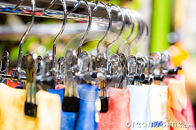 Silk scarfs on hangers in retail boutique shop Stock Photo