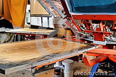 Silk screen textile printery. print screening apparatus selective focus photo. serigraph printing production. manual screen Stock Photo
