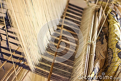 Silk weaving homemade traditional thai fabric. The process of si Stock Photo