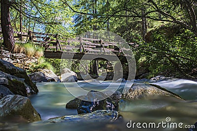 Silky water and wood bridge Stock Photo