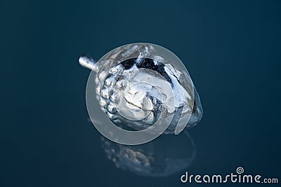 Silver acorn, autumn home decoration, advent christmas decoration, cold blue light Stock Photo