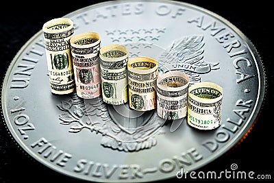 Silver american eagle coin with dollars forming falling steps Stock Photo