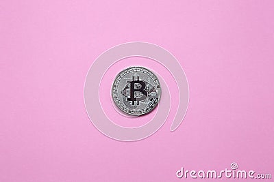 Silver bitcoin on a millennial pink background. Top view. Minimalism. Horizontal orientation. Flat lay Stock Photo