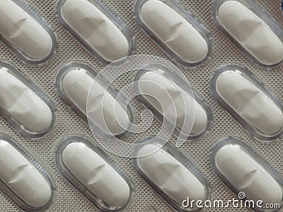 Silver blister with pills for illness and pain treatment. Medical drug package for tablet: vitamin, antibiotic, aspirin, tablets, Stock Photo