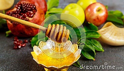 Silver bowl with honey and fruits for Yom Kippur Stock Photo